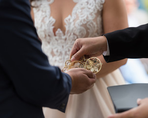 bride and groom holding wedding coins