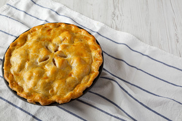 Homemade apple pie on cloth, side view. Copy space.