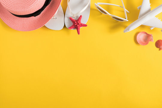 Summer Beach Composition. Glasses, Flip Flops, Hat, Starfish On Yellow Background. Summer Holiday Concept. Flat Lay, Top View, Copy Space