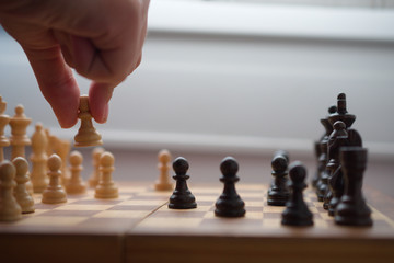 Man playing chess, moving a white tower