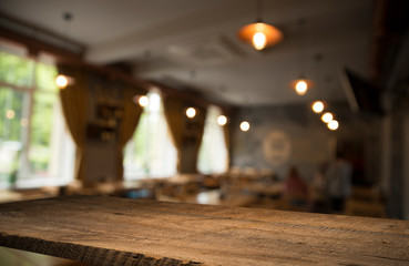 Empty wooden table in front of abstract blurred background of coffee shop . can be used for display or montage your products.Mock up for display of product
