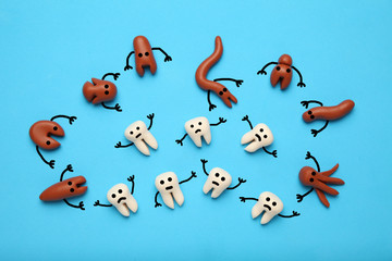 Baby teeth and scary cartoon caries concept. Prevention of oral cavity. Baby dental treatment.