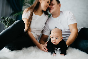 Portrait of a happy family with a little baby boy.