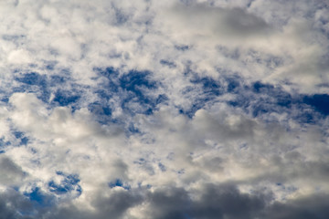 Clouds against the blue sky as a background