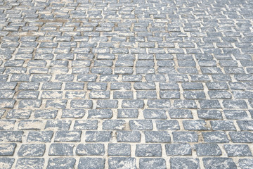 Gray Paving stone, background. Pedestrian zone in the park in daylight. Urban walkway.