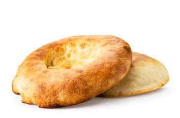 Fresh Uzbek flat cake close-up on a white. Isolated.