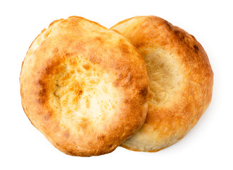 Two Uzbek flat cake on a white. The form of the top.