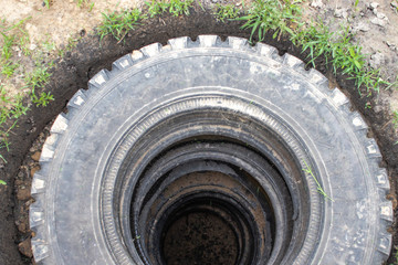 Sewer pit with car tires.
