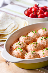 Chacken meatballs baked in creamy tomato sauce