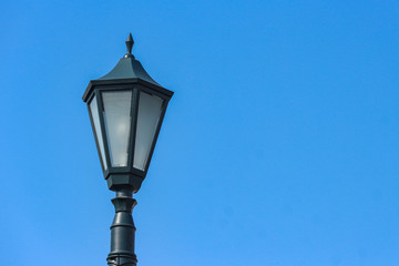 Fototapeta na wymiar A vintage light lamp with clear blue sky background.