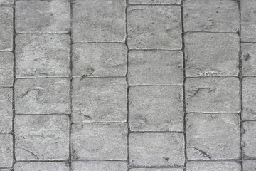 aged weathered gray stone paving walking way surface background.