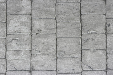 Fototapeta premium aged weathered gray stone paving walking way surface background.