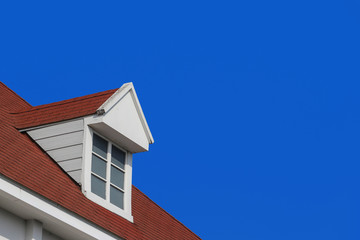 modern gable roof design house wall with clear blue sky background.