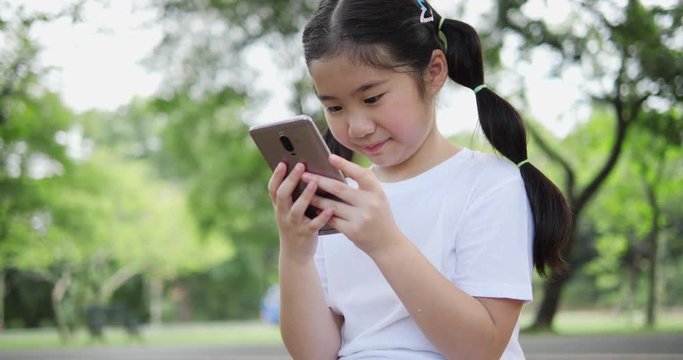 Asian little girl talking real time with smartphone. Girl meeting face to face with friends on internet. concept of technology, communication wireless and life experience. 4K resolution and slow motio