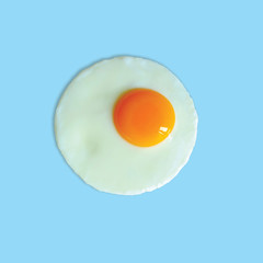Fried egg on light blue background