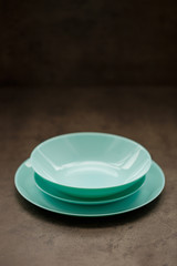 blue plates of different sizes and shapes on a gray background