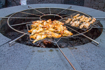 Chicken legs on the grill grill over the natural heat of a volcano in the El Diablo Canary Islands National Park. Spain Lanserote