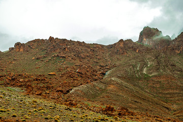 View of the Atlas Mountains in Morocco. Fog over high mountain peak