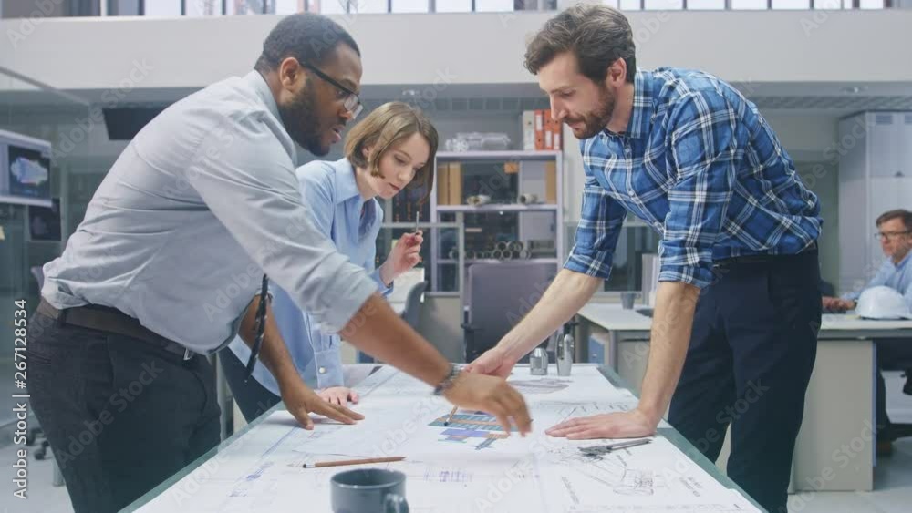 Poster in the industrial engineering facility: female designer works with industrial engineer and master te