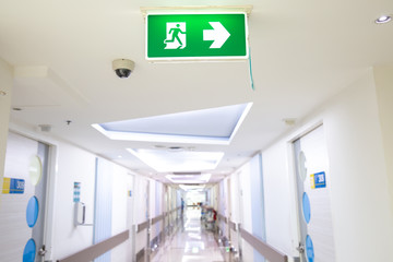 Green emergency exit sign showing the way to escape.Fire exit in the building.
