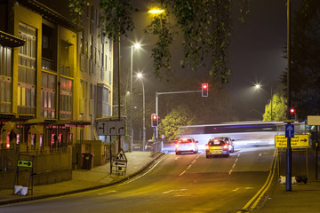 Fototapeta na wymiar A long exposure of traffic at a crossroads at night