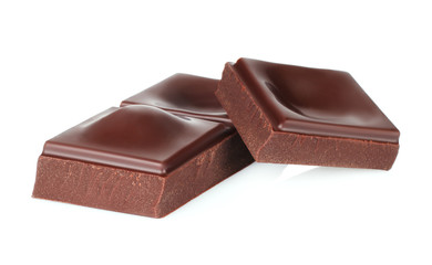 Dark chocolate pieces isolated on white background