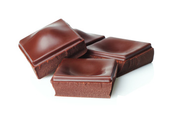 Dark chocolate pieces isolated on white background