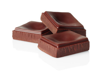 Dark chocolate pieces isolated on white background
