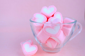 Transparent coffee cup filled with marshmallow. Cute pastel background, Valentine background