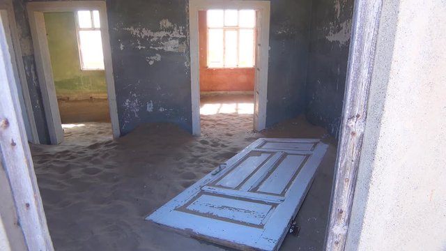 Sand fills an abandoned building in the gem mining ghost town of Kolmanskop, Namibia.
