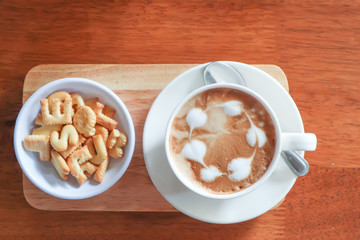 Coffee cup with latte art foam on wood table in coffee shop with copy space.Coffee is one of the most popular beverages.Improve Energy Levels and Burn Fat