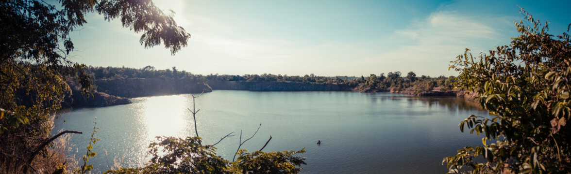 A Fisherman Is Fishing In A Lake From A Rubber Ring