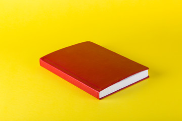 Red notepad on a yellow background, for decoration, for text design, for template