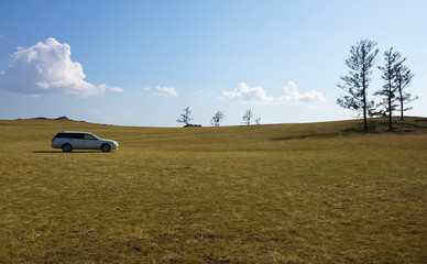 Naklejka premium The car is in the field to take the lake. Camping. Lake Baikal, steppe.