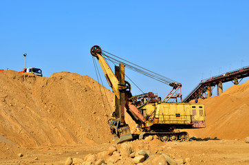 Large excavator in a quarry for the extraction of sand, gravel, rubble, quartz and other minerals