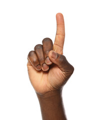 African-American man pointing at something on white background, closeup
