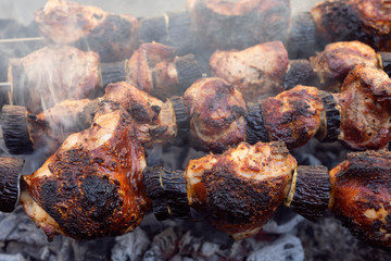 Obraz na płótnie Canvas Shish kebab. Pork, chicken and lamb meat pieces being fried on a charcoal grill. Cooking grilled pieces of meat