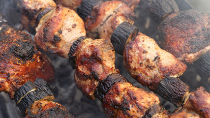 Obraz na płótnie Canvas Cooking meat and aubergine on hot charcoal. Shish kebab close up