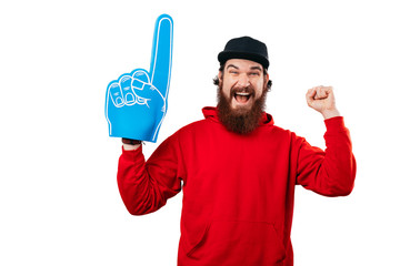 Fototapeta Excited fan, photo of bearded man supporting with big blue fan glove. obraz