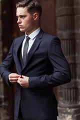 Modern businessman. Confident young man in full suit
