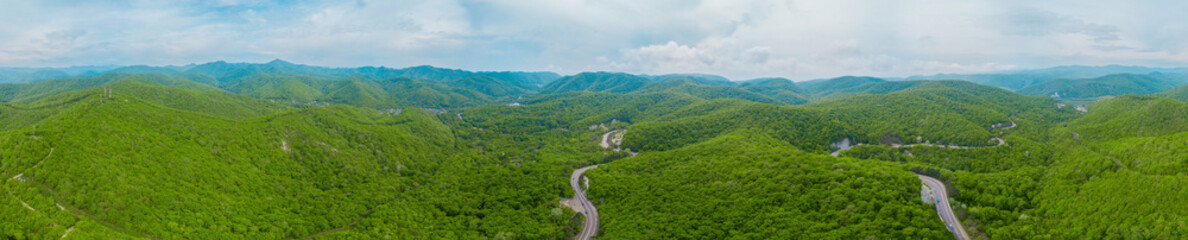 Naklejka na ściany i meble Caucasus mountains and forest panorama, rural road