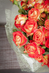 Large beautiful bouquet of orange roses in the package