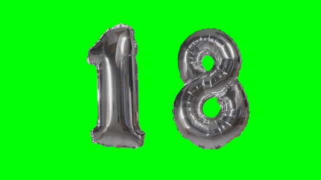 Number 18 eighteen years birthday anniversary silver balloon floating on green screen