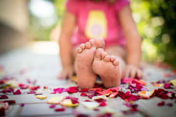 baby's feet and petals of roses