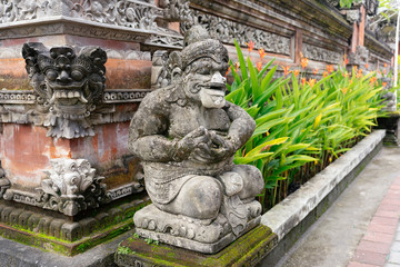 Naklejka premium Balinese statue near home entrance (gates) in Ubud, Bali. Detailed portrait.