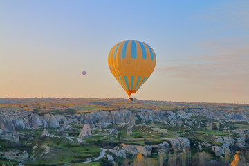 Quiet flight over the mountains in a balloon at sunrise.