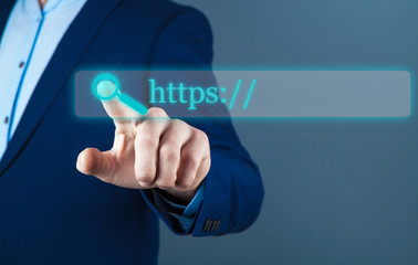 businessman on a dark background, touchscreen; web search
