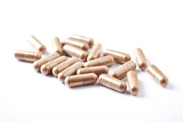 Reishi Mushroom capsules. Concept for a healthy dietary supplementation. White background. Close up. 