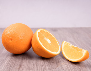 Closeup of oranges on a wooden table with white background