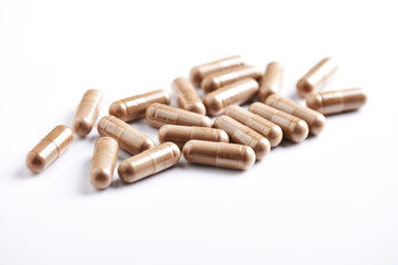 Reishi Mushroom capsules. Concept for a healthy dietary supplementation. White background. Close up. 